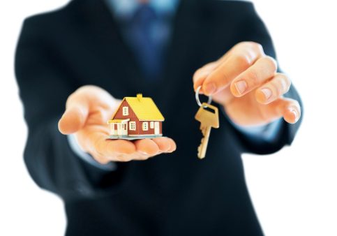 184128345 Male holding model house with key in hand