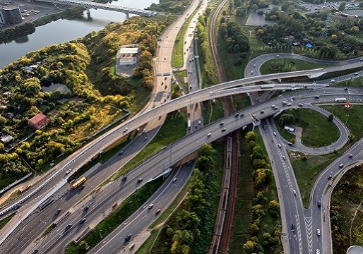 Large highway junction at the edge of Moscow. Branching of Volokolamsk Highway and Pyatnitskoe Highway. There is a metro bridge above Moskva river and railway line. Aerial view from helicopter, over 150 meters height.